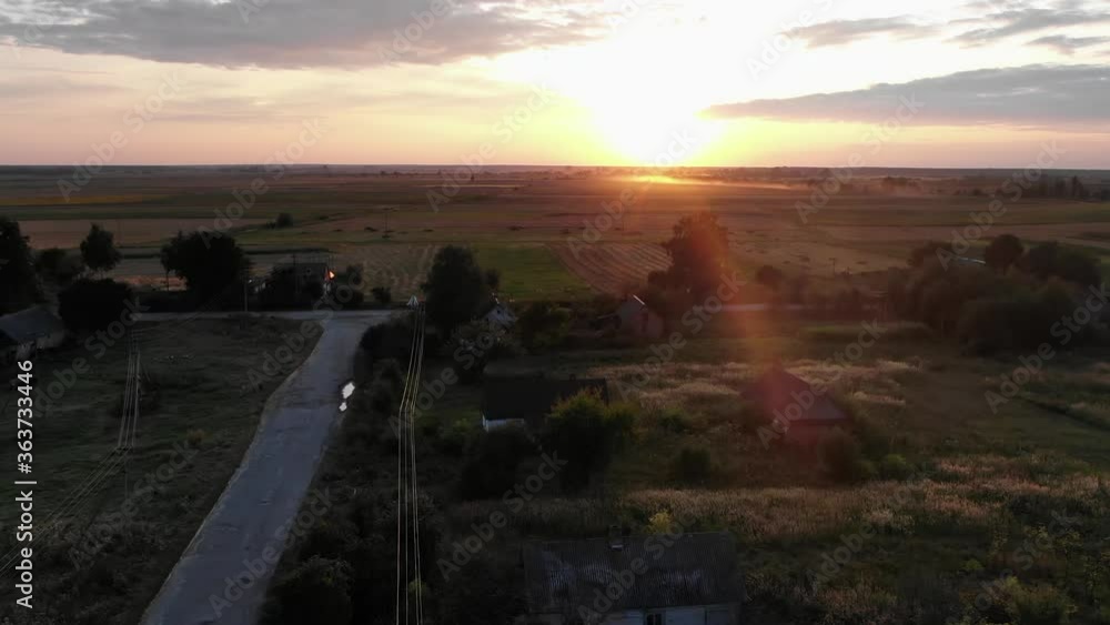 Aerial View of a Beautiful Sunset on the Horizon of a Small Farm Village Aerial View of a Beautiful Sunset on the Horizon of a Small Farm Village