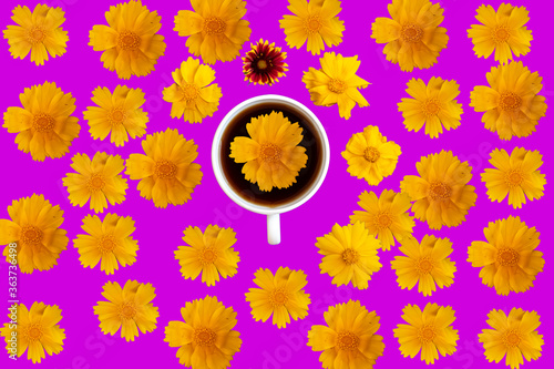 aerial view of a coffee cup sourounded by yellow flowers photo