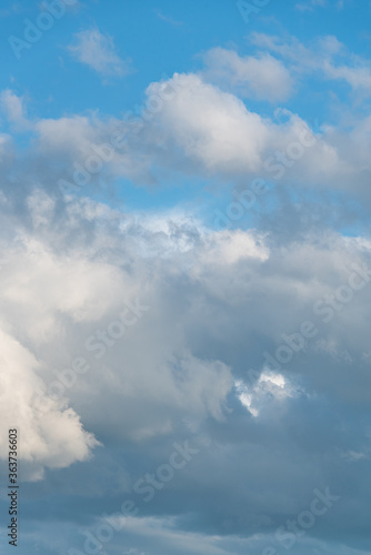 Atmospheric blue sky with gray and white clouds 