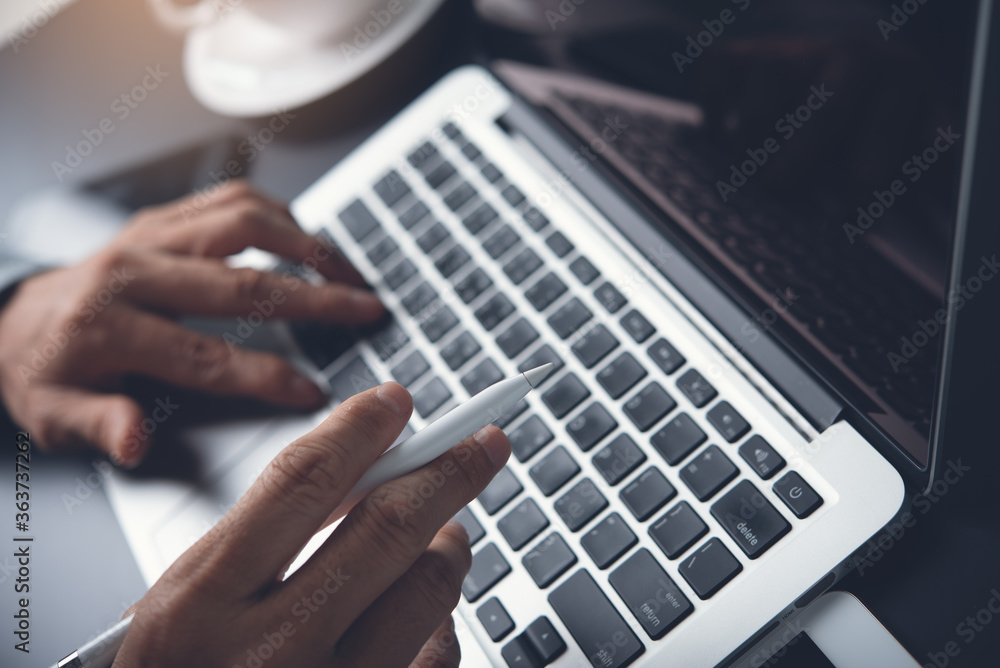 close up of man hand typing on laptop computer while online working in office close up of man hand typing on laptop computer while online working in office