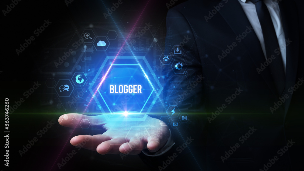 Man hand holding BLOGGER inscription, social media concept Man hand holding BLOGGER inscription, social media concept