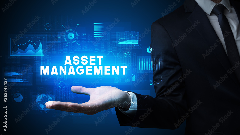 Hand of Businessman holding ASSET MANAGEMENT inscription, business success concept Hand of Businessman holding ASSET MANAGEMENT inscription, business success concept