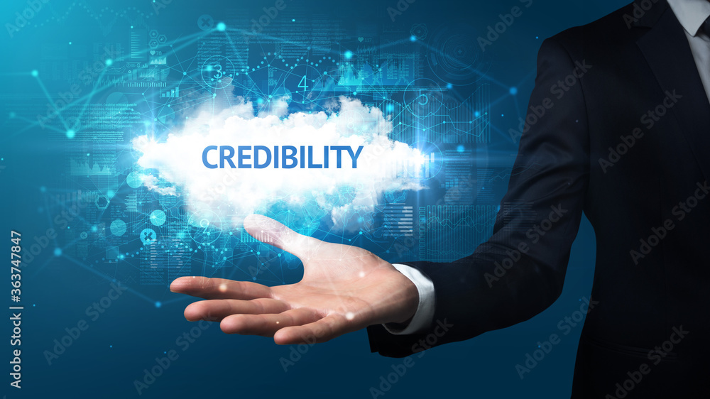 Obraz premium Hand of Businessman holding CREDIBILITY inscription, successful business concept