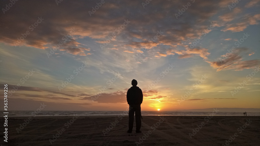 A man standing at Oretti beach Invercargill New Zealand