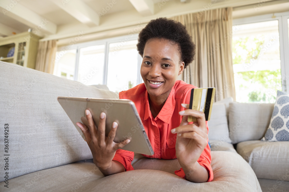 Portrait of woman holding digital tablet and credit card Portrait of woman holding digital tablet and credit card