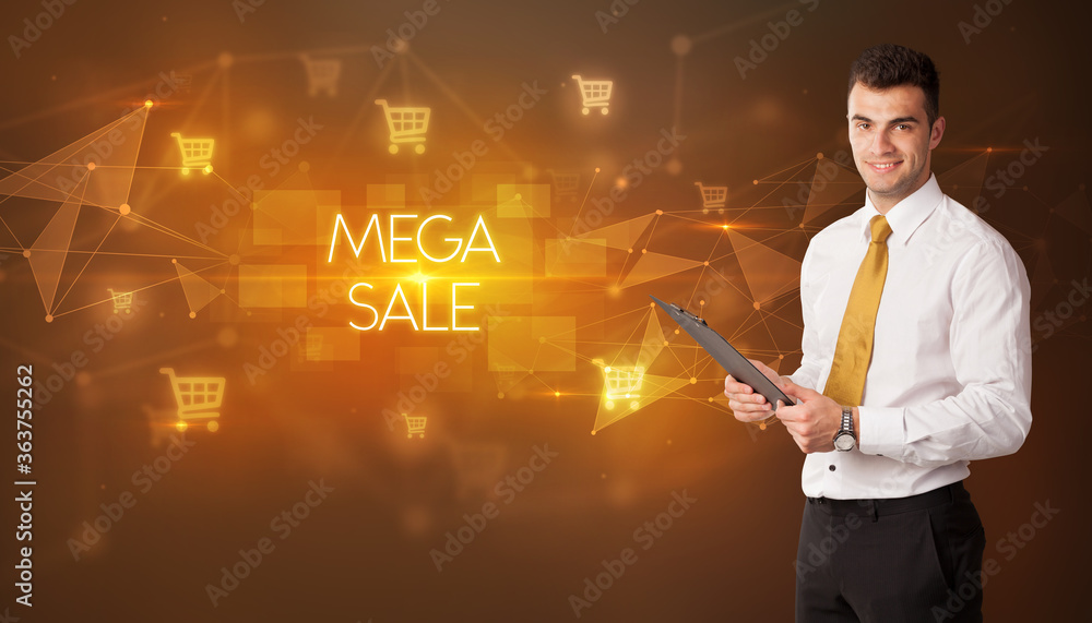 Businessman with shopping cart icons and MEGA SALE inscription, online shopping concept Businessman with shopping cart icons and MEGA SALE inscription, online shopping concept