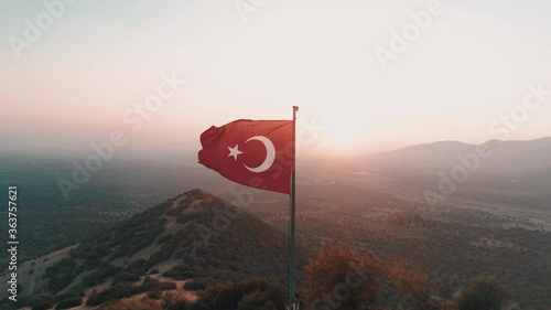 turkish flag at the top of the mountain. turkish flag at the top at sunset
