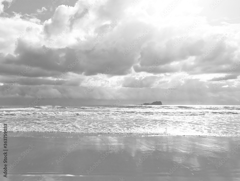 Australian beach with storm clouds and reflections in the sand, Mudjimba Beach, Queensland