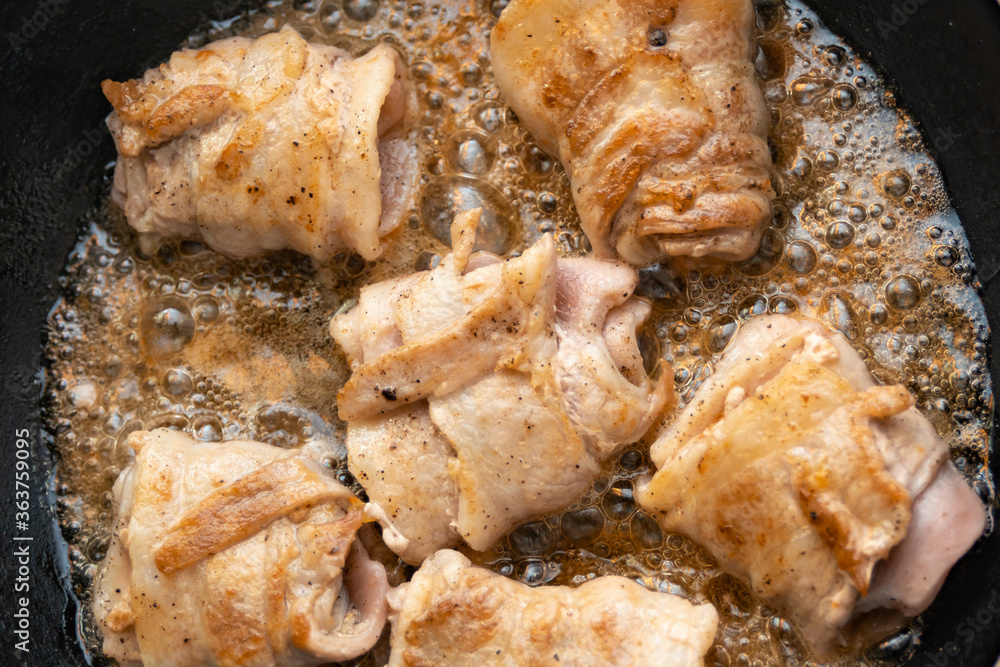 Cooking fried rolls with bacon in a pan. Cooking fried rolls with bacon in a pan.