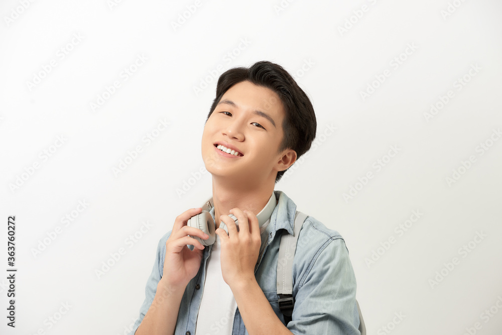 Portrait of smiling young college student with backpack against white background Portrait of smiling young college student with backpack against white background