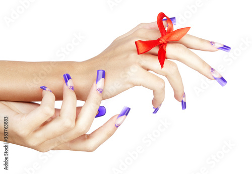 Hands with blue french acrylic nails manicure and painting with red bow on finger