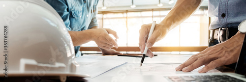 Engineer of architect starting draw a house blueprint on the desk in the office at construction working site