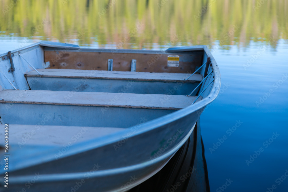 A close-up rowboat with reflection floating on Sequoia Lake, vacation A close-up rowboat with reflection floating on Sequoia Lake, vacation