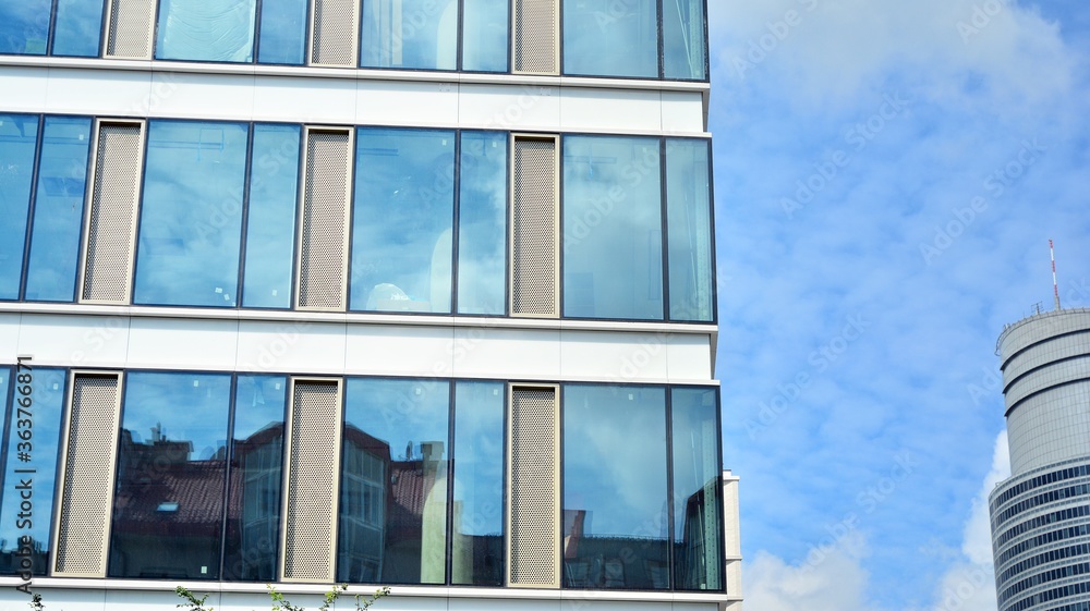 Facade texture of a glass mirrored office building. Fragment of the facade. Modern architecture of the office building. Facade texture of a glass mirrored office building. Fragment of the facade. Modern architecture of the office building.