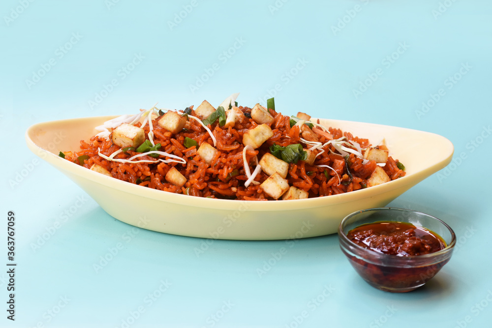 Schezwan paneer fried rice with schezwan sauce,Chinese fried rice with paneer,indo-chinese cuisine dishes. selective focus Schezwan paneer fried rice with schezwan sauce,Chinese fried rice with paneer,indo-chinese cuisine dishes. selective focus