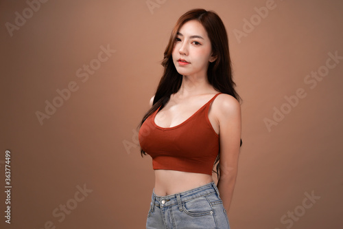 Tablou pe pânză Slim body and big breast asian woman, Red crop bralette outfit, isolated with mo