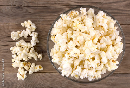 Popcorn in a bowl on a wooden table