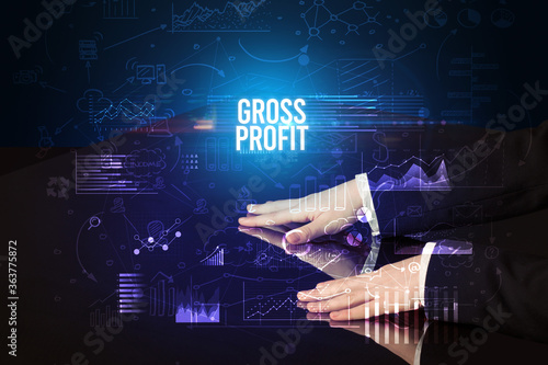Businessman touching huge screen with GROSS PROFIT inscription, cyber business concept