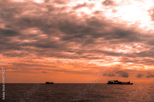 sunset over the sea © ArdichawatSripaiboo