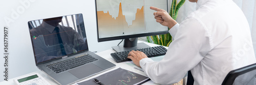 Obraz na plátně Stock market analysis successful broker or traders looking and focused talking about forex charts and data on multiple computer screens of stock market