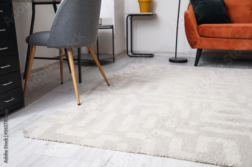 Stylish interior of living room with carpet