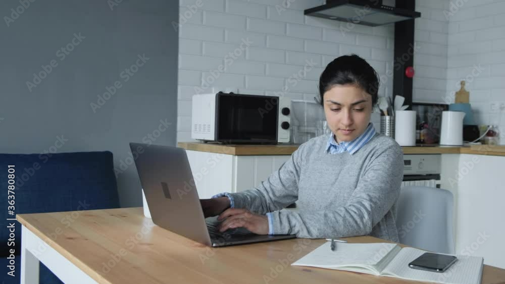 Thoughtful concerned indian woman working on laptop computer looking away thinking solving problem at home office, serious woman search for inspiration make decision feel lack of ideas, close up view Thoughtful concerned indian woman working on laptop computer looking away thinking solving problem at home office, serious woman search for inspiration make decision feel lack of ideas, close up view