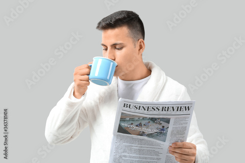 Handsome young man with cup...
