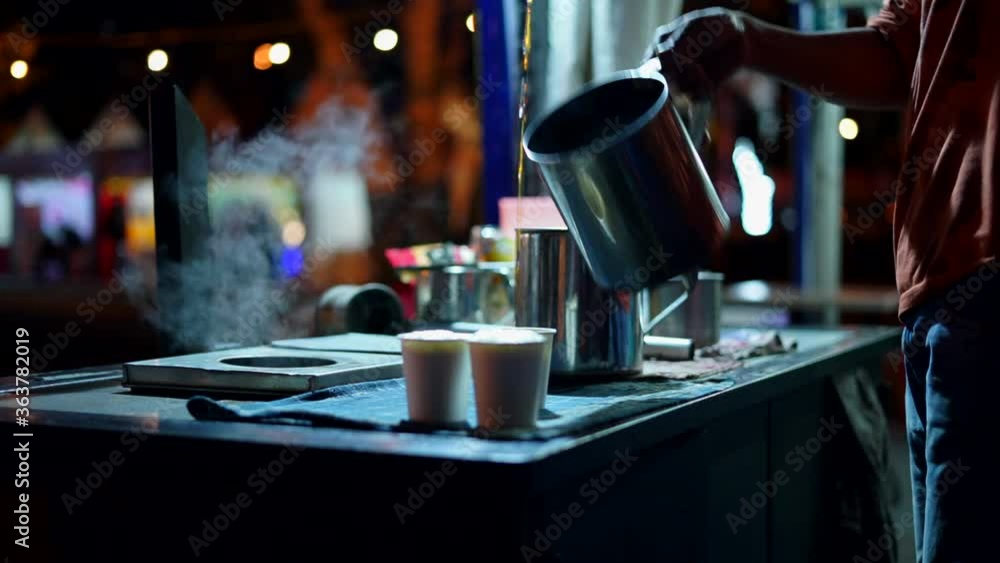 Acehnese barista manually pouring coffee in traditional method, also known as Kupi Sareng Aceh Acehnese barista manually pouring coffee in traditional method, also known as Kupi Sareng Aceh