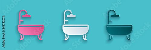 Paper cut Bathtub icon isolated on blue background. Paper art style. Vector Illustration.