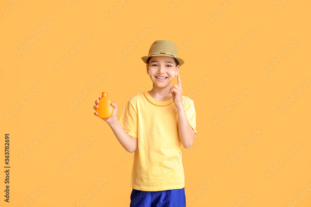 Little boy with sun protection cream on color background Little boy with sun protection cream on color background