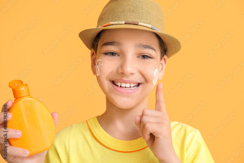 Little boy with sun protection cream on color background Little boy with sun protection cream on color background