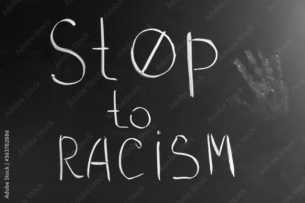 Text STOP TO RACISM written on chalkboard Text STOP TO RACISM written on chalkboard