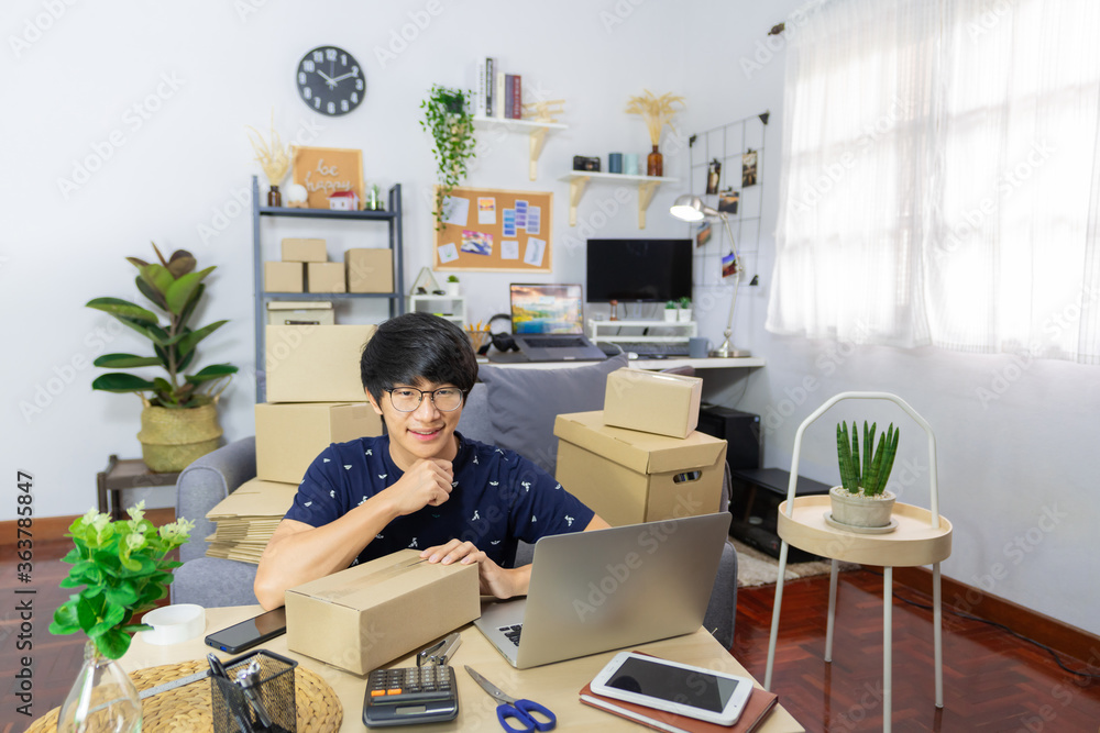 Asian man business owner working with laptop for checking packaging delivery e-commerce online market on purchase orders to customer
Asian man business owner working with laptop for checking packaging delivery e-commerce online market on purchase orders to customer