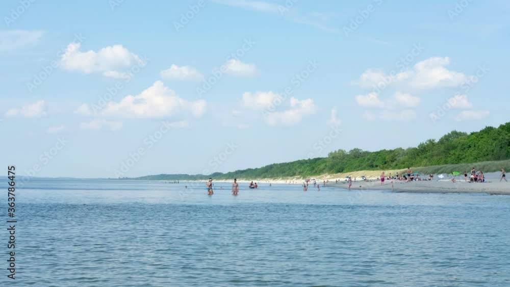 The public beach of the Baltic Sea in the Kaliningrad Region, the city of Baltiysk in summer The public beach of the Baltic Sea in the Kaliningrad Region, the city of Baltiysk in summer
