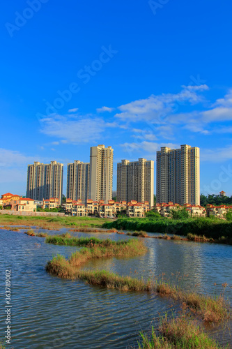 Green living building residential area under the blue sky and white clouds.