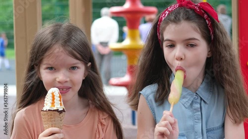 little children eat ice cream in the playground