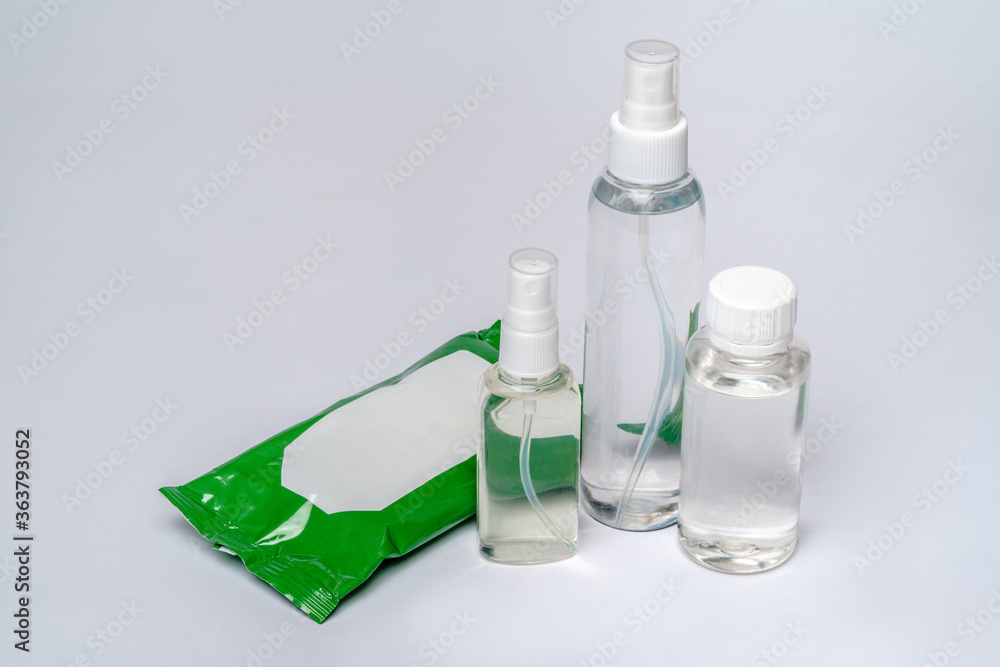 group of hand sanitizer spray or liquid soap bottles over light grey background group of hand sanitizer spray or liquid soap bottles over light grey background
