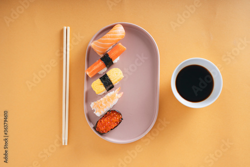 Japanese Shushi on a plate with shoyu soy sauce and chop stick. photo