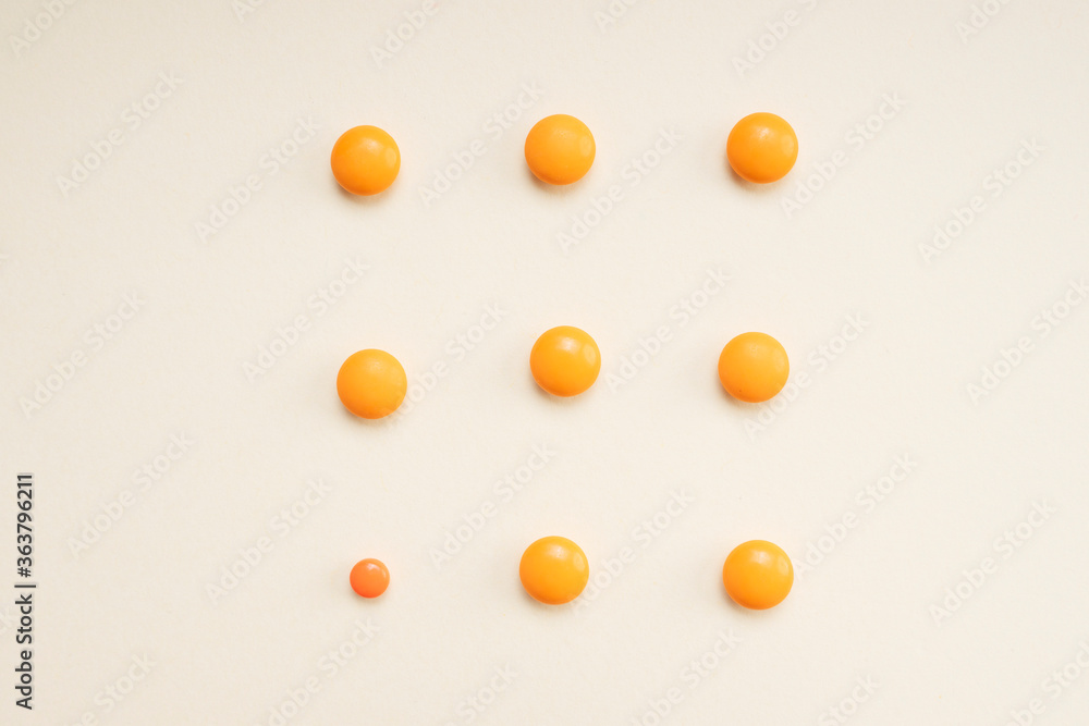 Medicine orange pills circle shape isolate over white background.