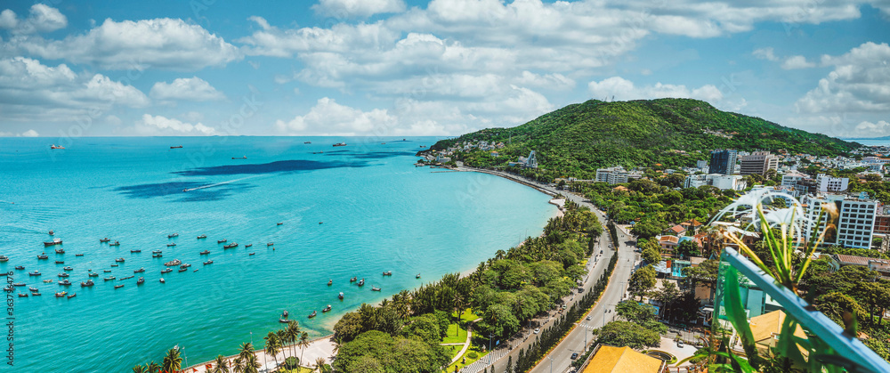 Panoramic coastal Vung Tau view from above, with waves, coastline, streets, coconut trees and Tao Phung mountain - obrazy, fototapety, plakaty 