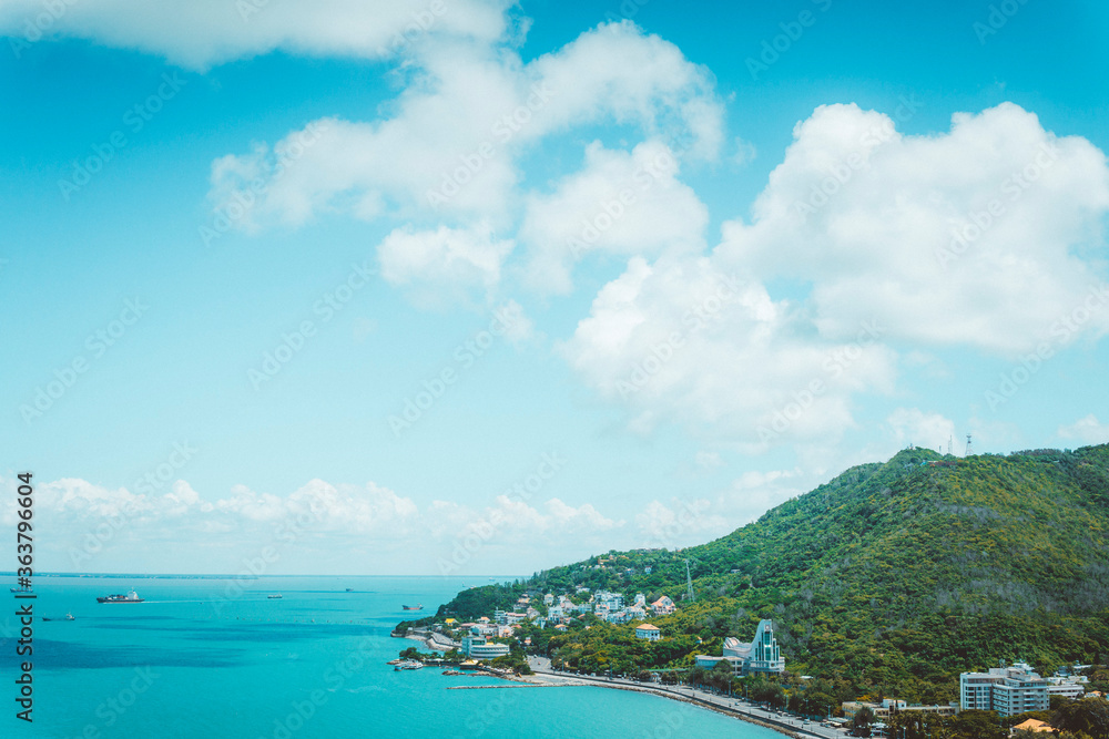 Panoramic coastal Vung Tau view from above, with waves, coastline, streets, coconut trees and Tao Phung mountain