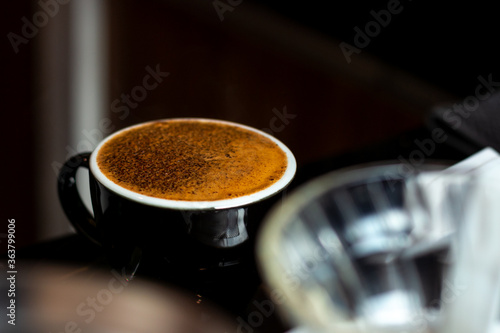 coffee foam on black cup in the coffee shop 