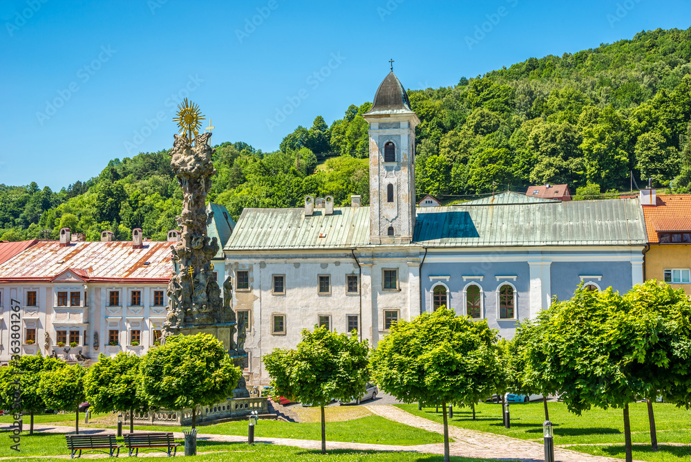 View at the Plague Column of Holy trinity with Cloister building in Kremnica, Slovakia