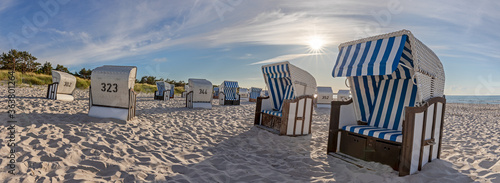 Bild auf Leinwand Beach with canopied beach chairs in evening light