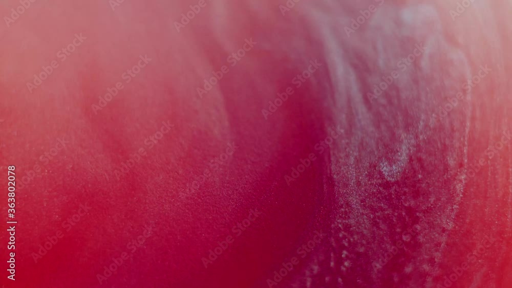 Abstract liquid red background. Surface with a moving flow of paint, creative drops of color Abstract liquid red background. Surface with a moving flow of paint, creative drops of color