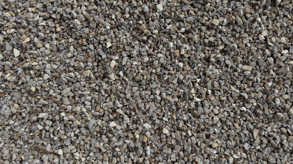 The texture of stone gravel gray. Stone rubble gray poured pile close-up. The texture of stone gravel gray. Stone rubble gray poured pile close-up.