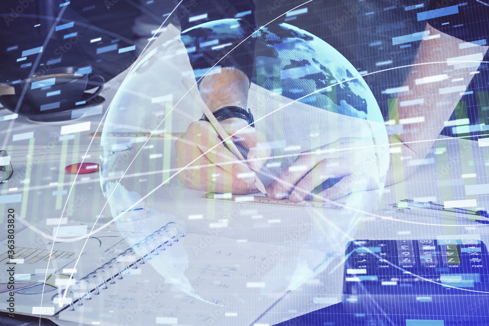 Double exposure of hands and notepad with business icons. Double exposure of hands and notepad with business icons.