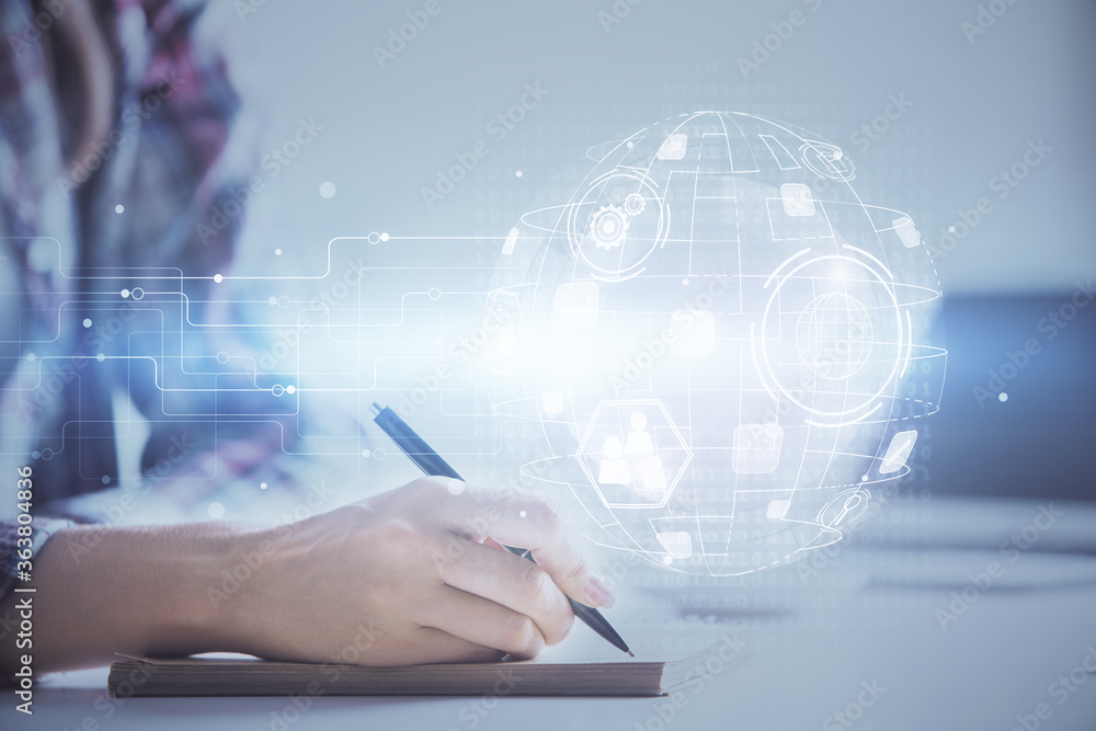 Social network theme hologram over hands taking notes background. Concept of global international people connect. Double exposure