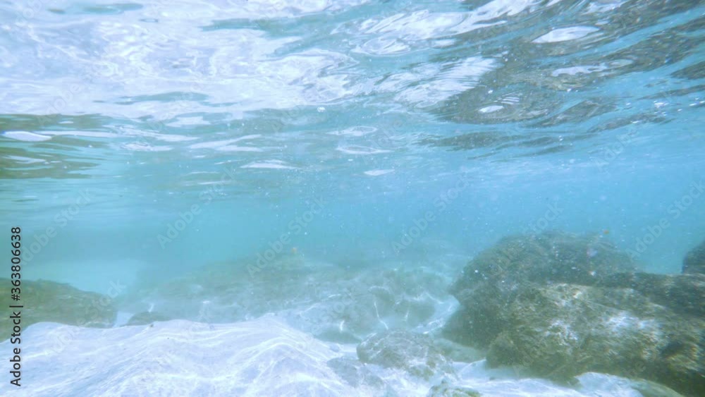 Sun rays sun beams underwater. Underwater shot of ecosystem and ocean floor in turquoise ocean. Sun rays sun beams underwater. Underwater shot of ecosystem and ocean floor in turquoise ocean.