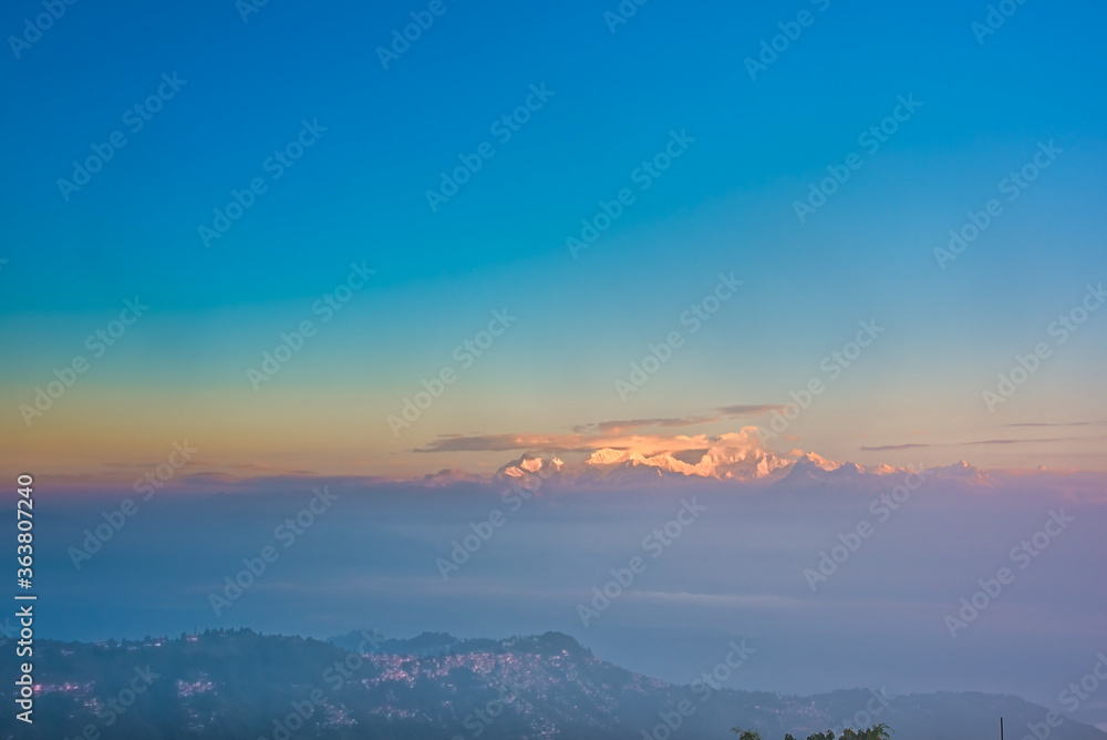 From Tiger Hill in Darjeeling to the Himalayan mountain range after sunrise the mountains are glowing and covered in clouds and fog, the colors of nature are beautiful divided into layers